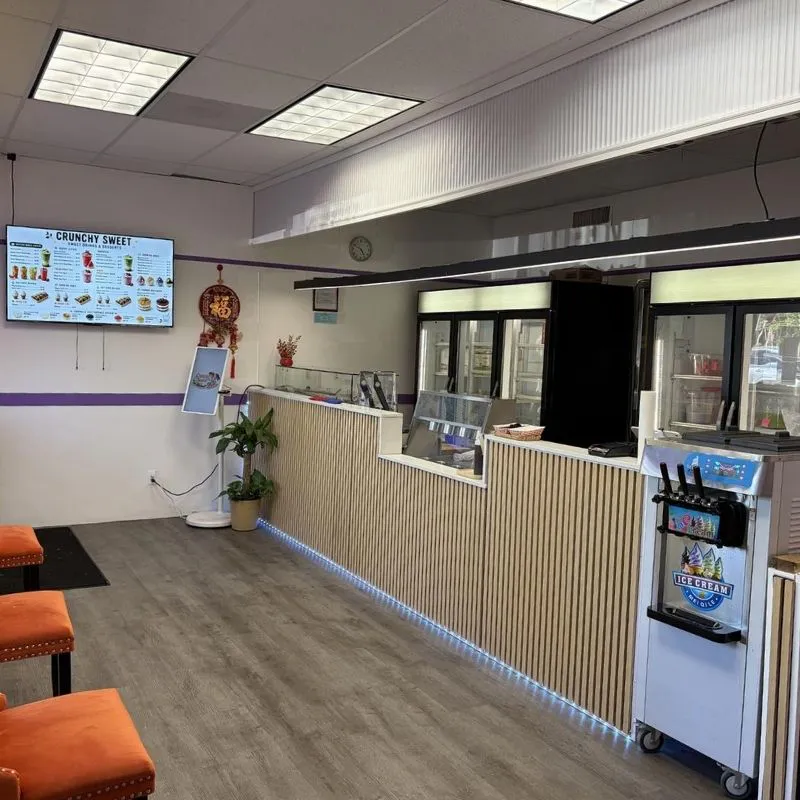 Bright interior counter area with digital menu screen at Crunchy Sweet, a Ice Cream Shop in Portland